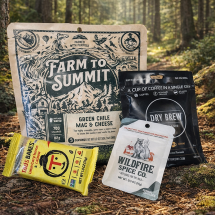 Outdoor food collection banner featuring trail meals, energy bars, spices, and camp-ready snacks from brands like Farm to Summit, Taos Bakes, Dry Brew, and Wildfire Spice Co.