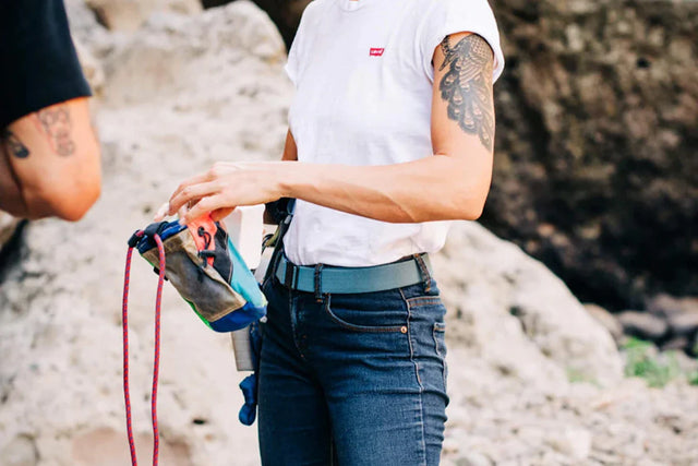 Women wearing Arcade Belt while outdoors on a hike.