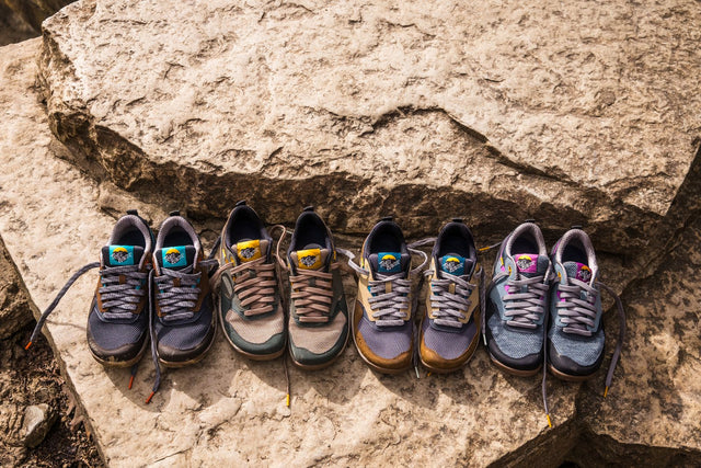 Lems Trail Blazer hiking shoes in a rugged outdoor setting, featuring a minimalist zero-drop design with durable outsole and breathable upper for trail use.