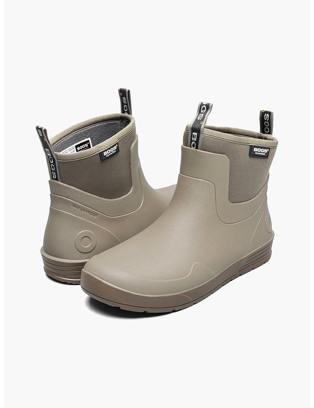 Pair of beige rubber boots with a visible Bogs logo on a white background