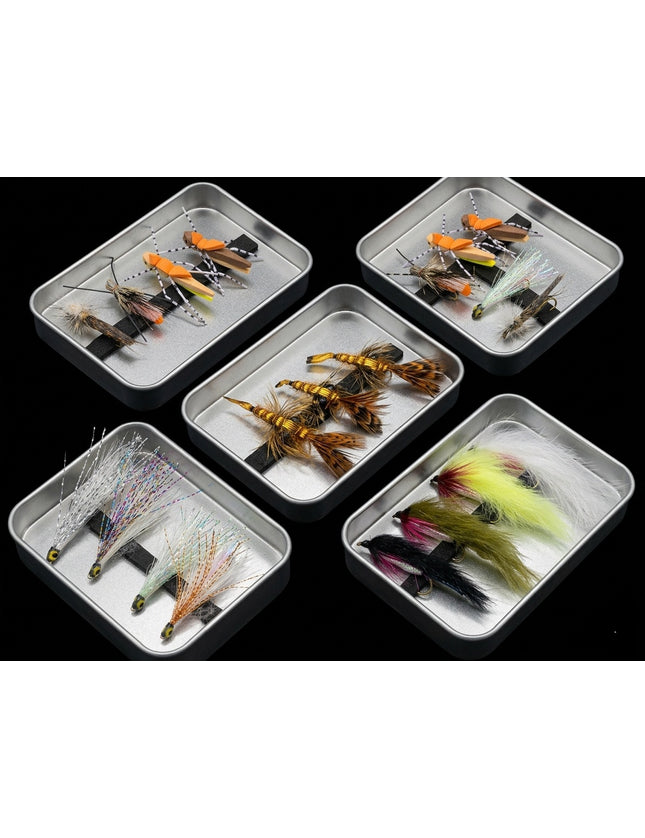 Set of fishing lures in small metal trays on a black background