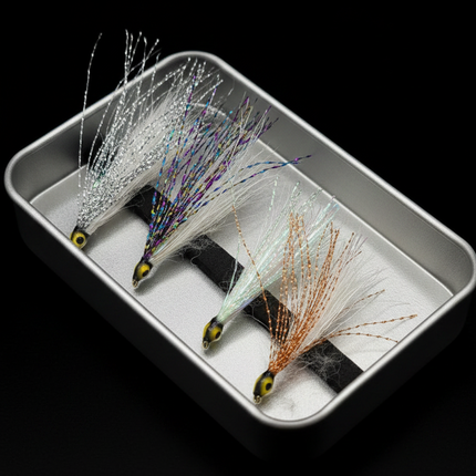 Three fishing lures on a metal tray with a black background