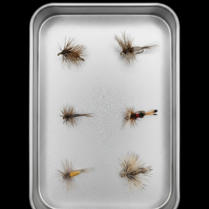 Size fly fishing flies on a metal tray with a black background