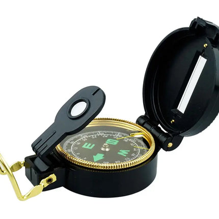 Black and gold compass with an open lid and a small magnifying glass