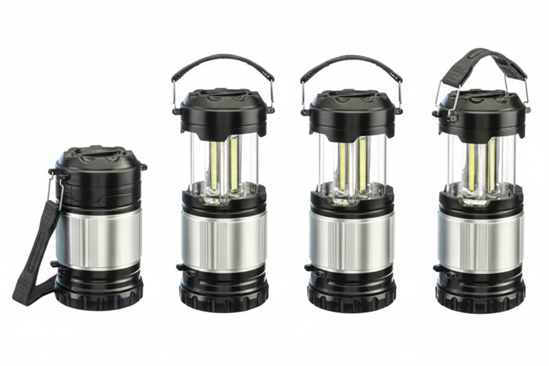 Four black and silver camping lanterns, one collapsed, three extended with LED lights visible
