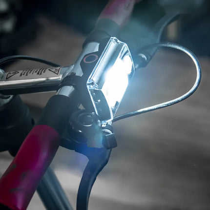 Bicycle handlebar with a bright white front light attached