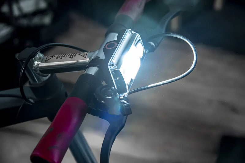 Bicycle handlebar with a bright white front light attached