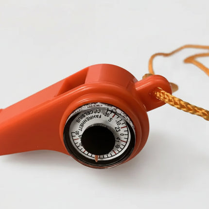 Orange whistle with a built-in thermometer showing Fahrenheit and Celsius scales