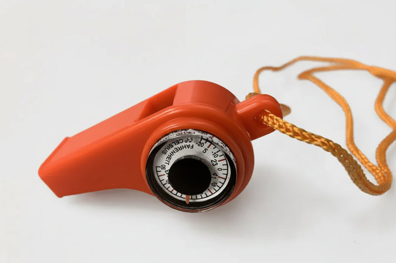 Orange whistle with a built-in thermometer showing Fahrenheit and Celsius scales