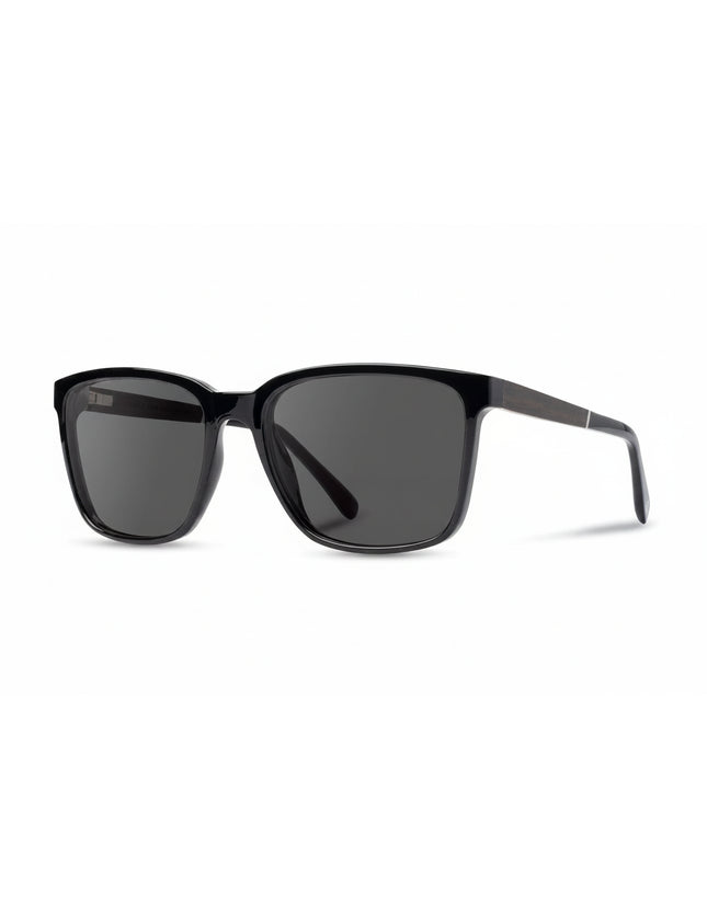 Black sunglasses with dark lenses on a white background