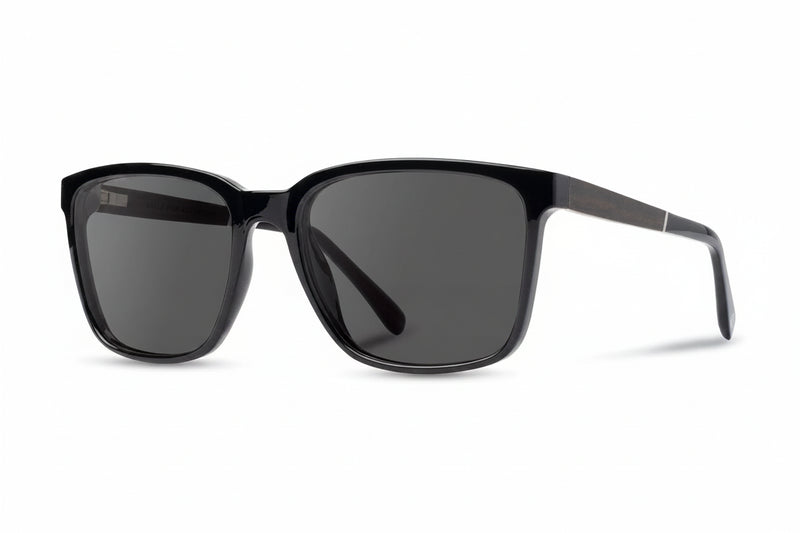 Black sunglasses with dark lenses on a white background
