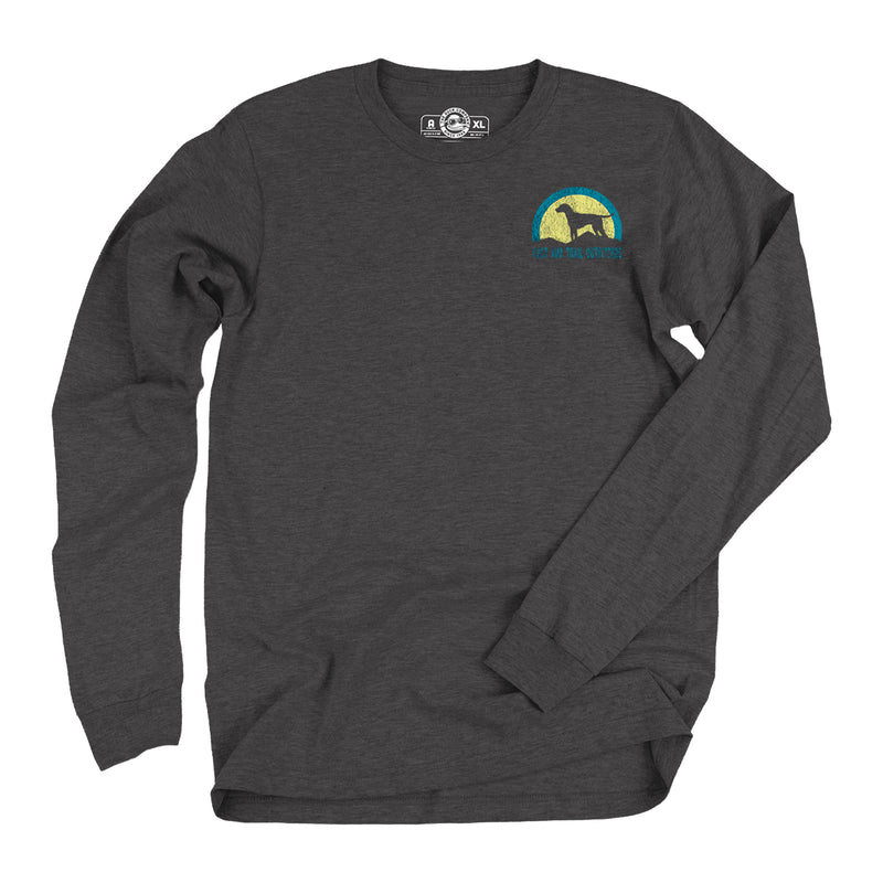 Dark grey long sleeve t-shirt with a graphic of a dog on a hill in front of a yellow and blue sunset with words Cast and Trail Outfitters.