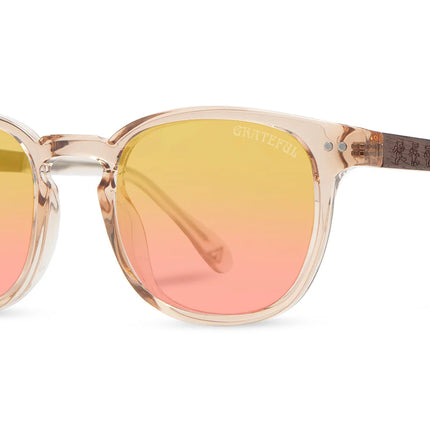 Sunglasses with gradient yellow to pink lenses on a white background