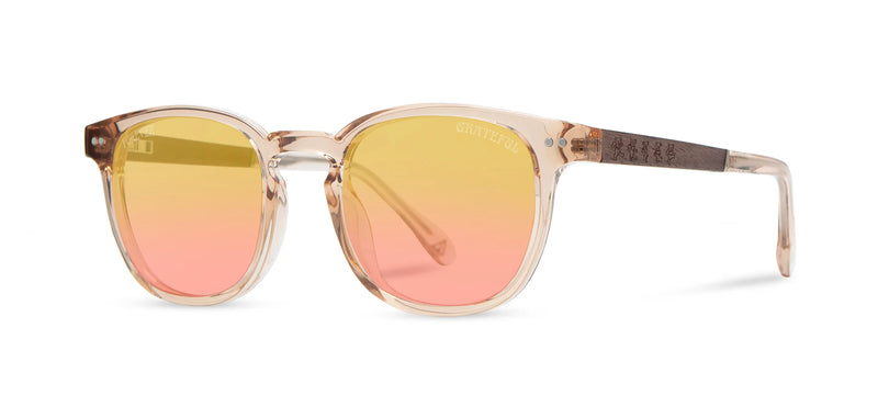 Sunglasses with gradient yellow to pink lenses on a white background