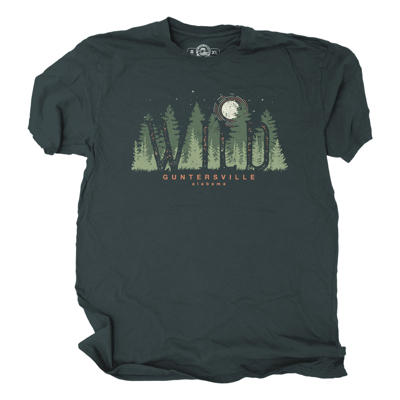 Dark green t-shirt with forest graphic, wild in text, and text stating Guntersville Alabama on a white background
