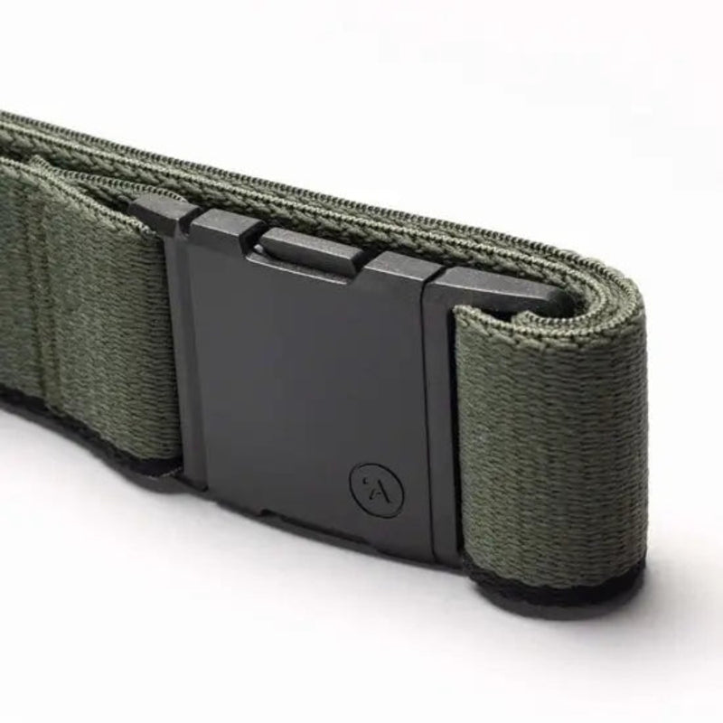 Close up of a green fabric belt with a black plastic buckle