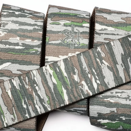 Close up of a camouflage patterned strap, with a subtle logo visible on one section