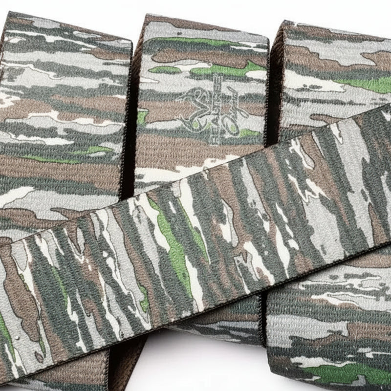 Close up of a camouflage patterned strap, with a subtle logo visible on one section