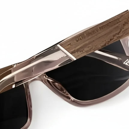 Close up of brown sunglasses with black lenses and a wooden arm