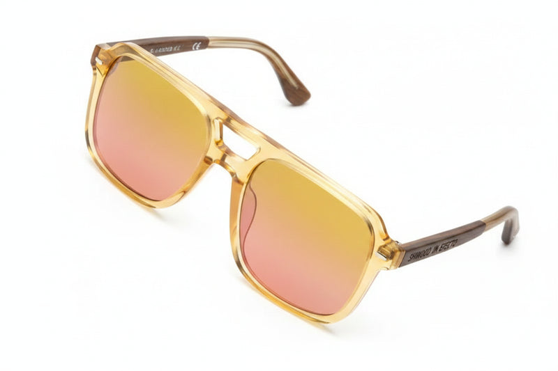 Square frame sunglasses with clear frames and yellow to pink gradient lenses