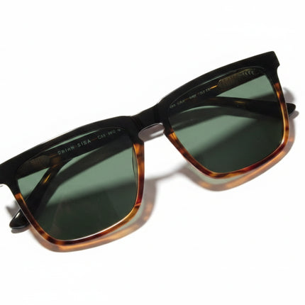 Black and tortoiseshell sunglasses with dark lenses