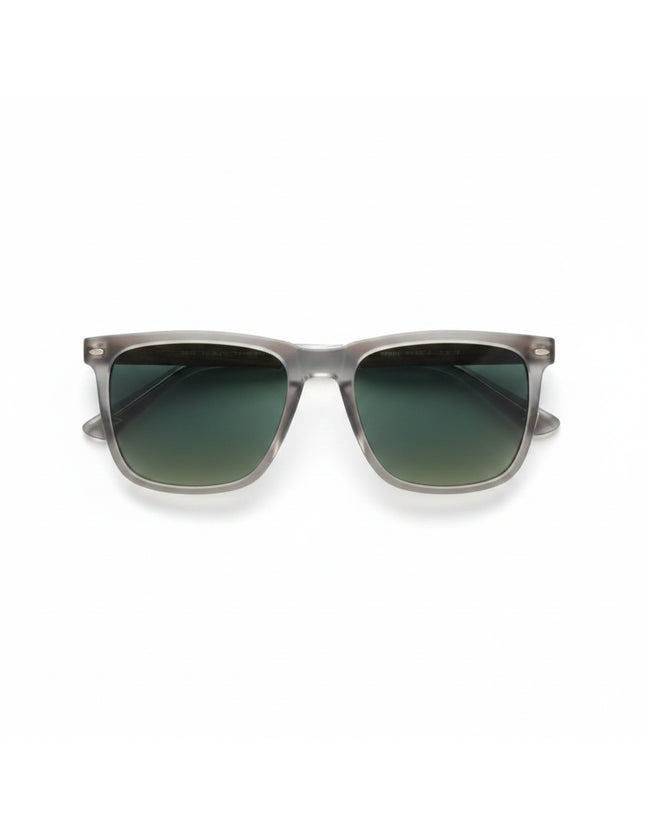 Top-down view of sunglasses with clear frames, green lenses, and wood-grain arms