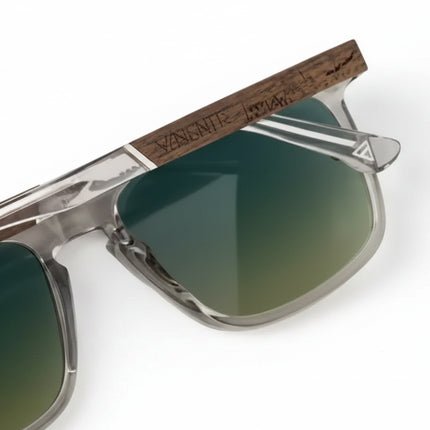 Close up of sunglasses with clear frames and dark wooden arms