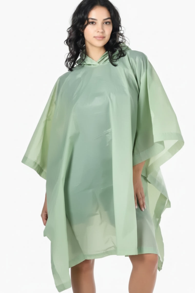 Woman wearing a light green hooded rain poncho