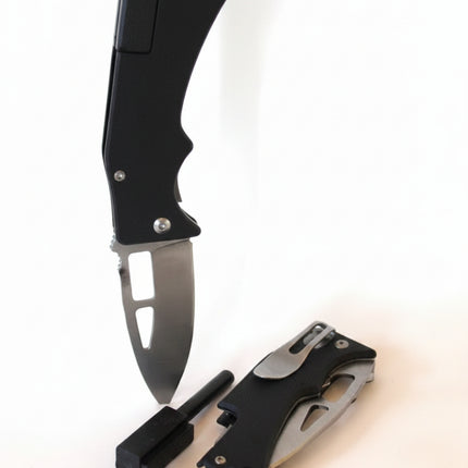 Two black folding knives, one open and one closed, with a small black sharpening tool and a silver bullet