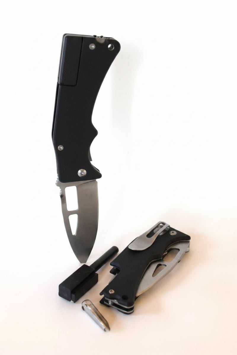 Two black folding knives, one open and one closed, with a small black sharpening tool and a silver bullet