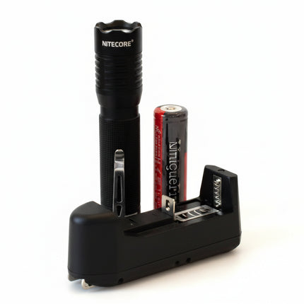 Black flashlight, red battery, and black battery charger