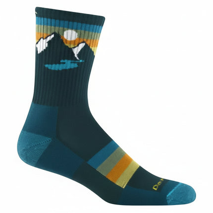 Dark teal sock with mountain and lake graphic, horizontal stripes in blue, orange, and yellow