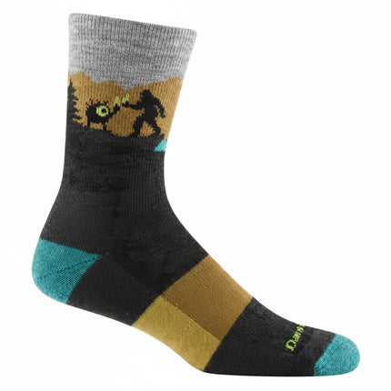 Black sock with a grey cuff, a brown and green landscape, and a silhouette of Bigfoot