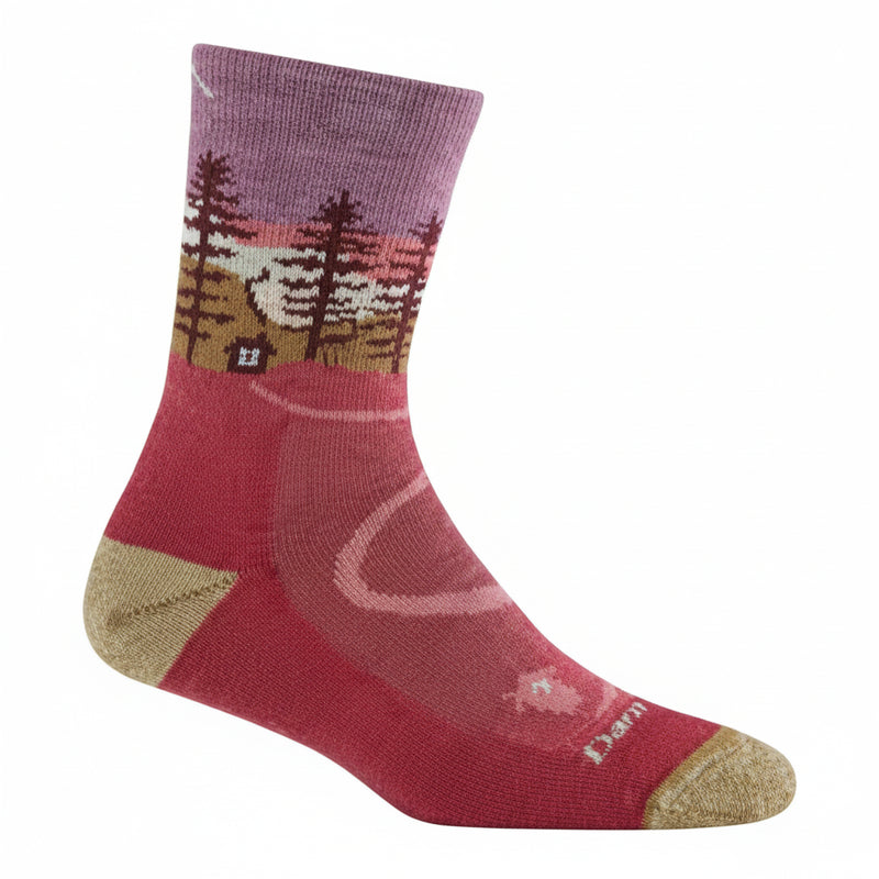 Red sock with a purple cuff and a forest and cabin design
