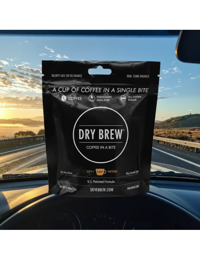 Dry Brew coffee in a bite pouch on a car dashboard with a sunrise background