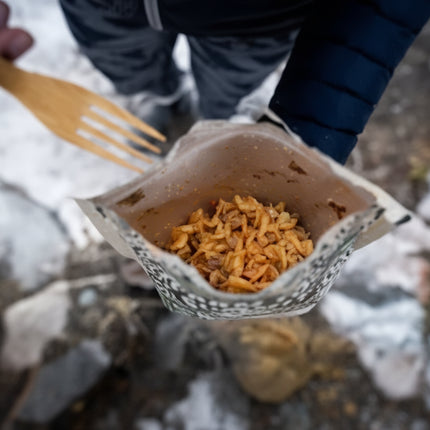 Dehydrated meal in a pouch with a wooden spork