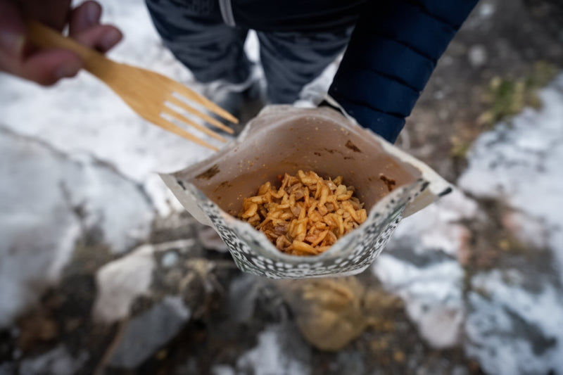 Dehydrated meal in a pouch with a wooden spork