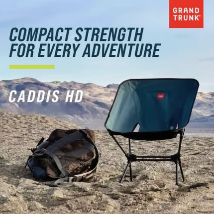 Grand Trunk Caddis HD chair and carrying bag on a sandy landscape with mountains in the background