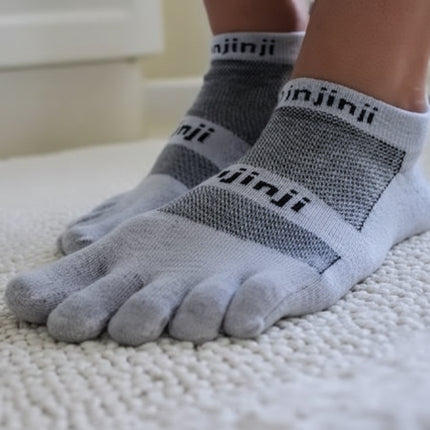 Pair of grey Injinji toe socks on a person's feet