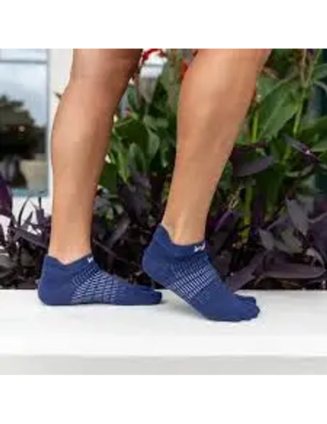 Person wearing blue toe socks with white pattern