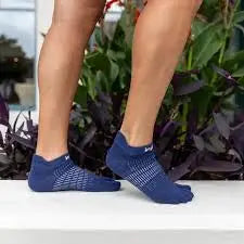 Person wearing blue toe socks with white pattern