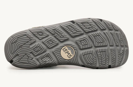 Close-up of a gray shoe sole with brand logo on a white background