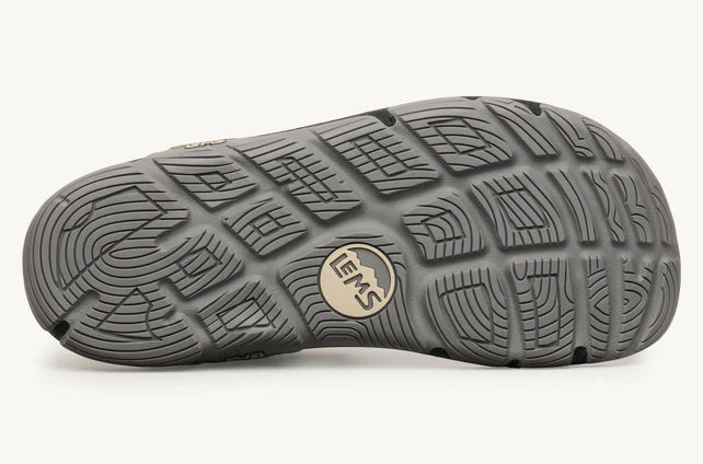 Close-up of a gray shoe sole with brand logo on a white background