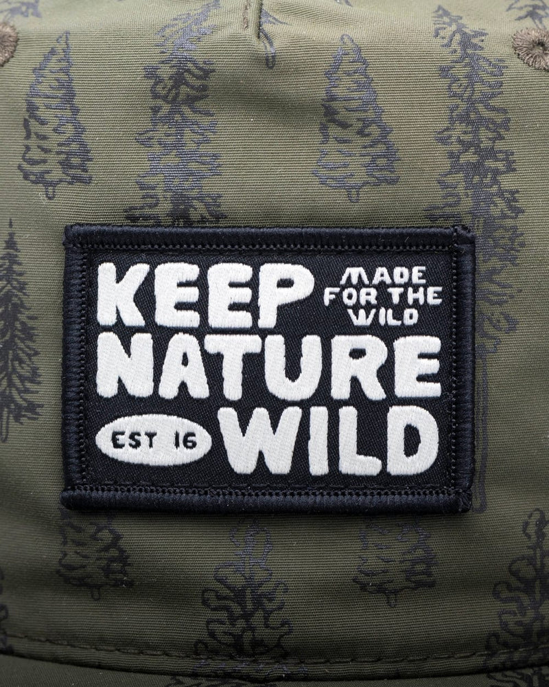 Close-up of a rectangular embroidered patch on olive green camouflage fabric. The patch is black with white text reading 'KEEP NATURE WILD' and smaller text 'MADE FOR THE WILD' and 'EST 16'.