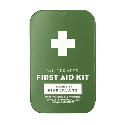 Green first aid kit with a white cross and text Wilderness First Aid Kit Prepared by Kikkerland