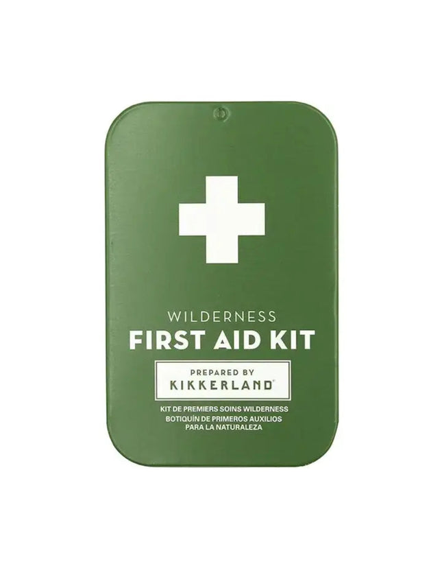 Green first aid kit with a white cross and text Wilderness First Aid Kit Prepared by Kikkerland