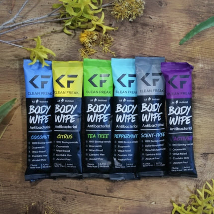 Six individually wrapped body wipes in a row, each a different color and scent