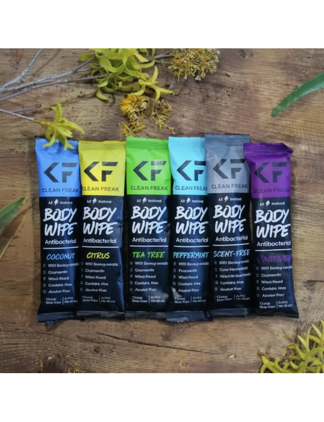 Six individually wrapped body wipes in a row, each a different color and scent
