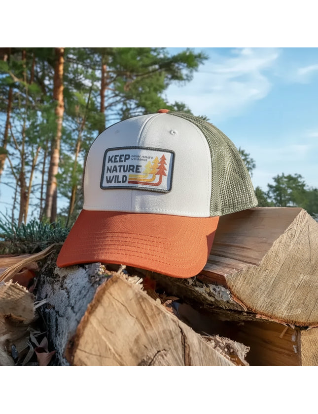 Keep Nature Wild hat on a pile of logs