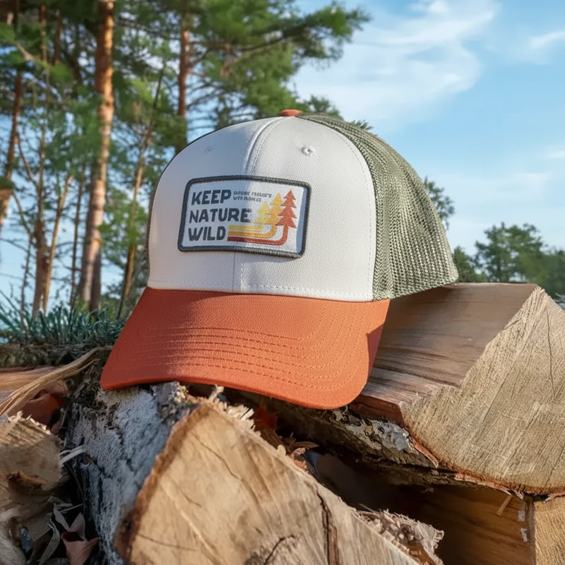 Keep Nature Wild hat on a pile of logs
